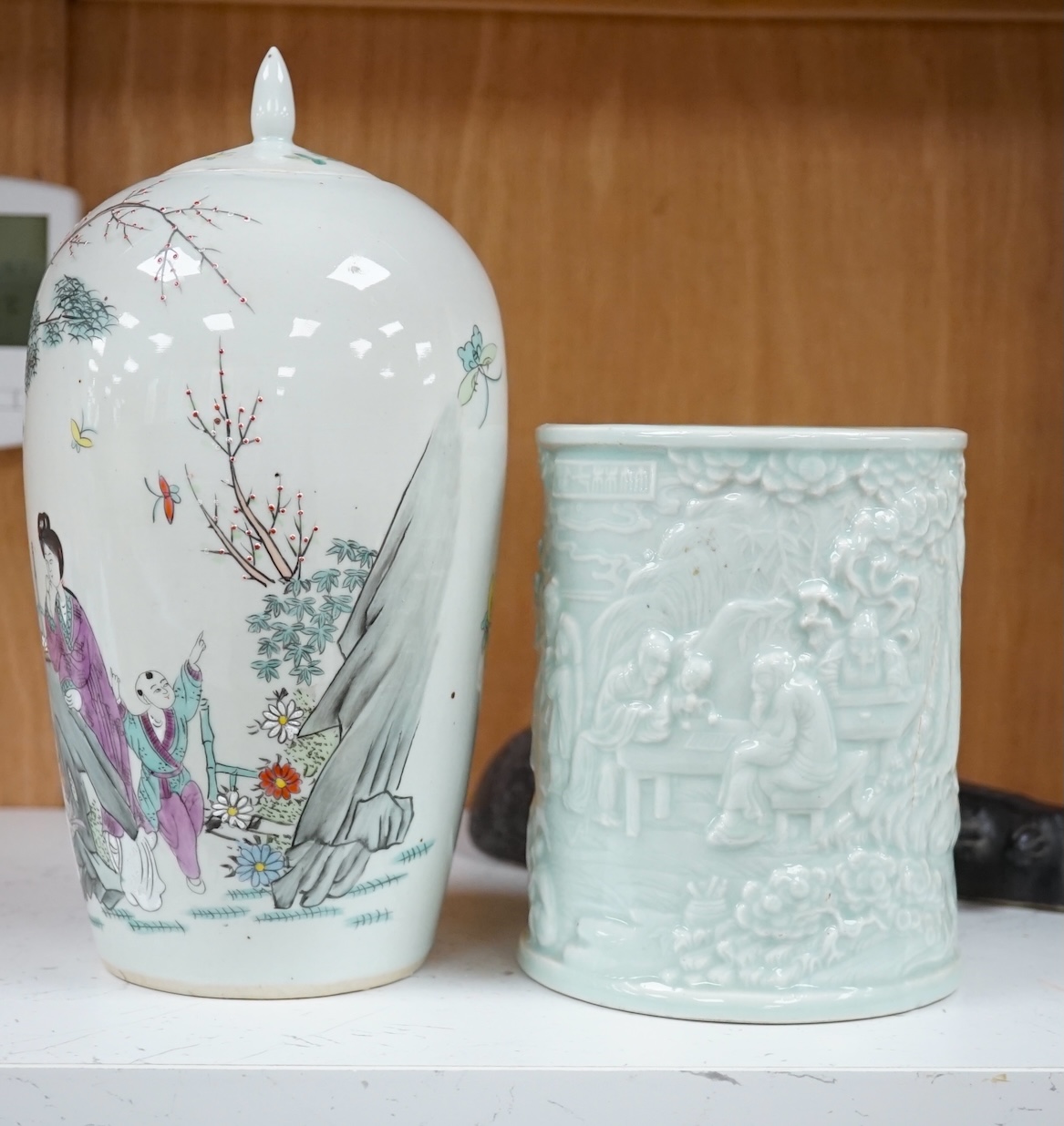 Three Chinese items comprising model of a stringed instrument (Pipa?), a celadon glazed brush pot and famille rose jar and cover, Republic period, 25cm high. Condition- fair to good